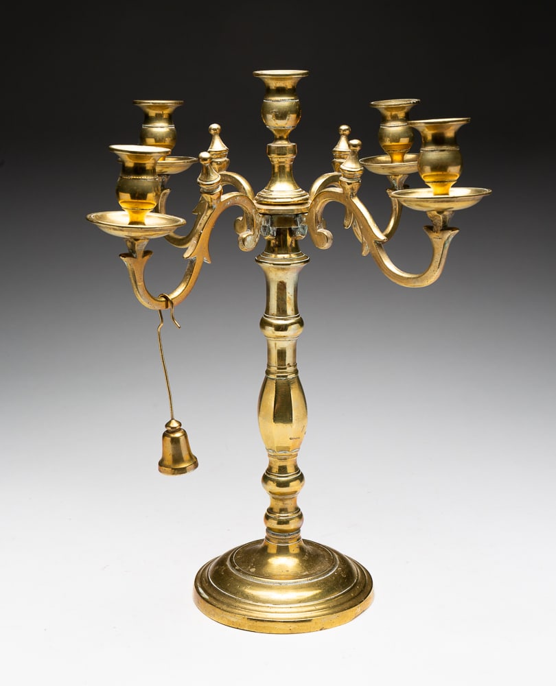 BRASS FOUR ARM CANDELABRA.: European, second quarter 19th Century. Round base with four scroll arms and a center cup. Arms rotate on base. With extinguisher. Surface wear. 15.5"h.