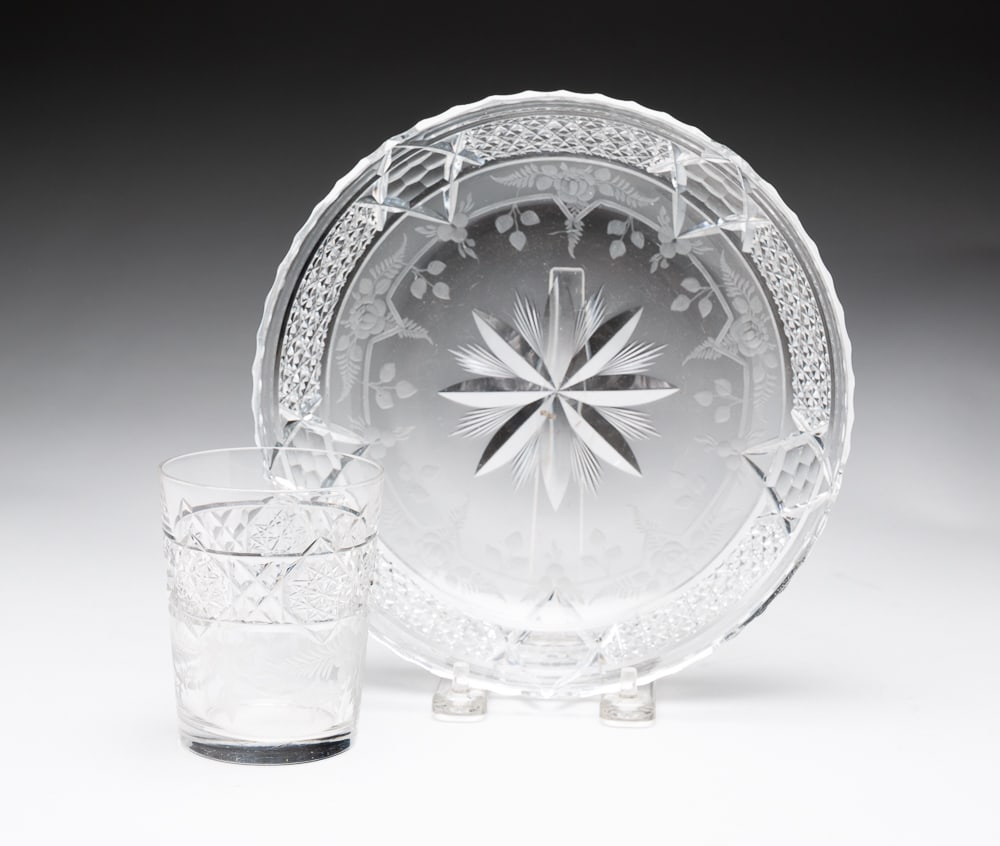 HAWKES CUT GLASS BOWL AND CUP.: American, circa 1900. Ribbed, scalloped rim with traditional cross-hatch design and floral etching, 8"dia. And matching glass, 3.75"h. Both with acid etched Hawkes mark. Surface wear and scratches.
