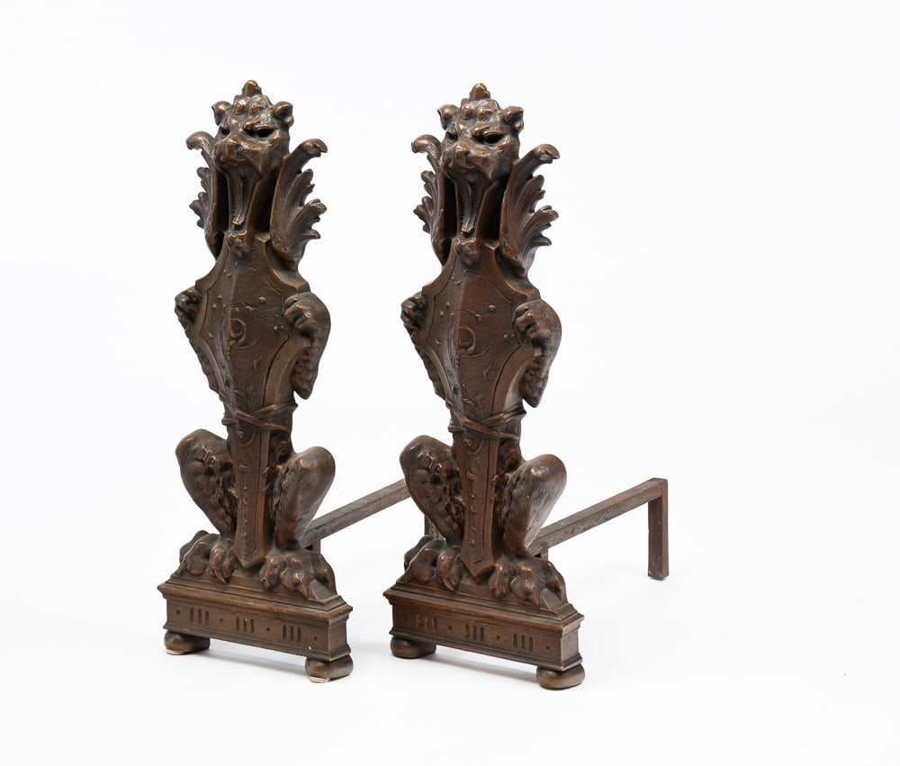 PAIR OF FIGURAL ANDIRONS.: Early-20th Century. Brass and iron. Standing lions with shields, 27"h. 10"w. 20"d.