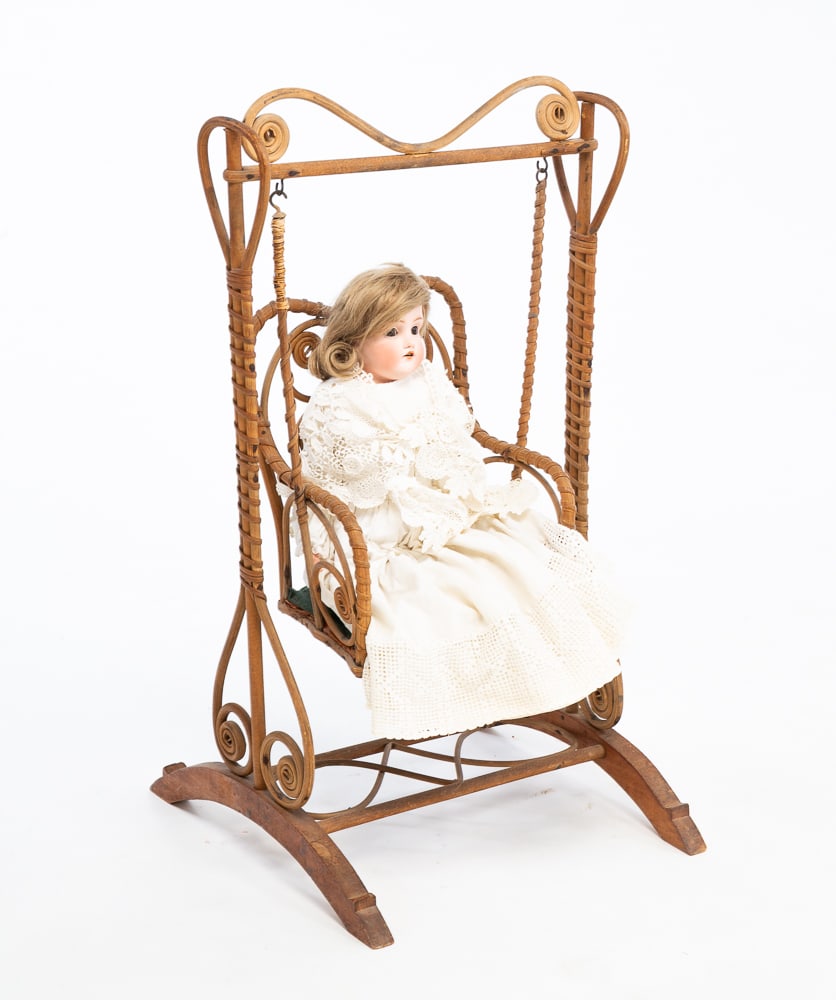 DOLL WITH CHAIR SWING.: Mid-19th Century. Bisque head jointed doll. Bentwood chair swing on frame. 25.5"h. 14"h.