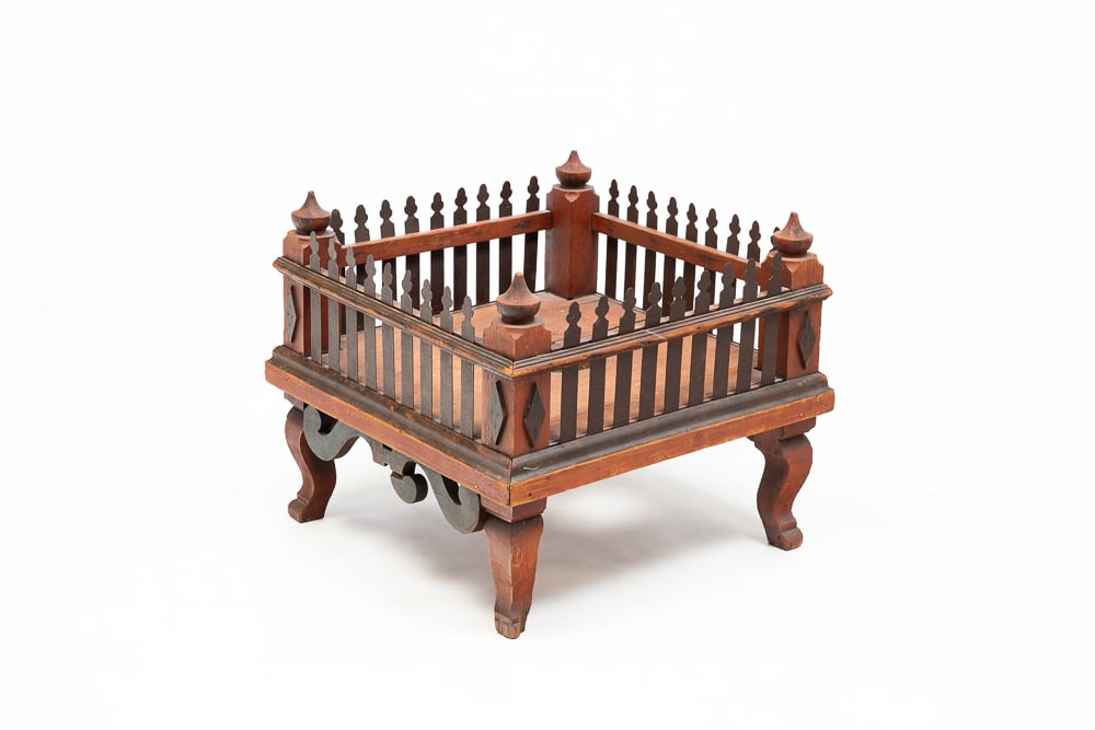 PICKET FENCE CHRISTMAS TREE STAND.: German, circa 1900. Wood and sheet metal fence on raised legs. Hole cut to center for tree. Wear and loss. 14.25"h. 16.75"w.