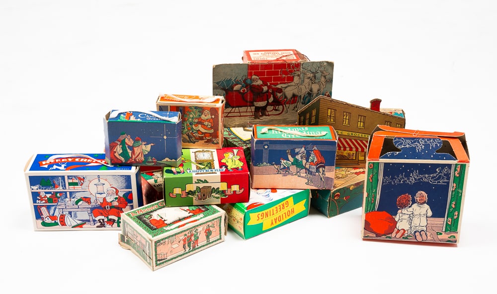 GROUP OF CHRISTMAS CANDY BOXES.: American, mid-20th Century. Fifteen cardboard boxes with colorful scenes. Also includes one Easter chocolate egg box. Wear and loss.