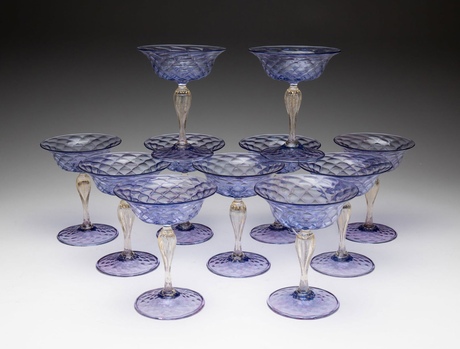 ELEVEN BLOWN VENETIAN GLASS SHERBETS.: Italian, mid-20th Century. Amethyst feet and cups, twisted hollow stems with gold mica flakes. Folded rims at foot. 5.75"h.