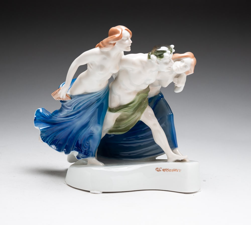 ROSENTHAL FIGURINE BY A. CASSMAN.: Selb-Bavarian, 20th Century. Porcelain. Titled "Storming Bacchantes". Bacchus flanked by two women. Mold number K190. 8"h.