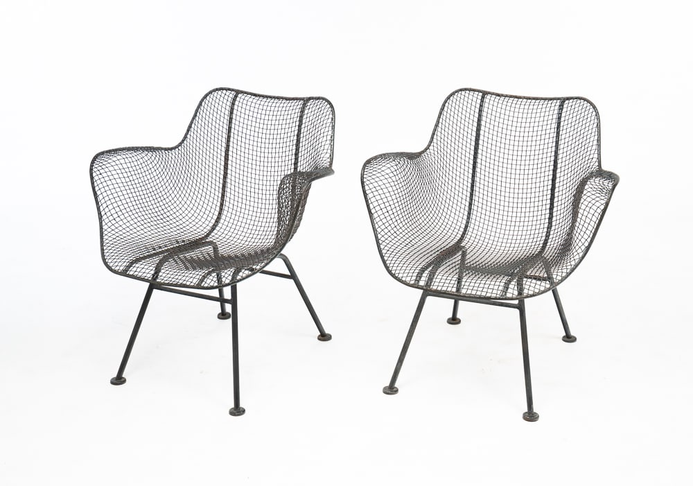 RUSSELL WOODARD SCULPTURAL LOUNGE CHAIRS.: American, mid-20th Century. Black painted wrought iron sculpted armchairs on splayed leg bases. Wear. Seat 14.5"h. Overall 27.5"h.