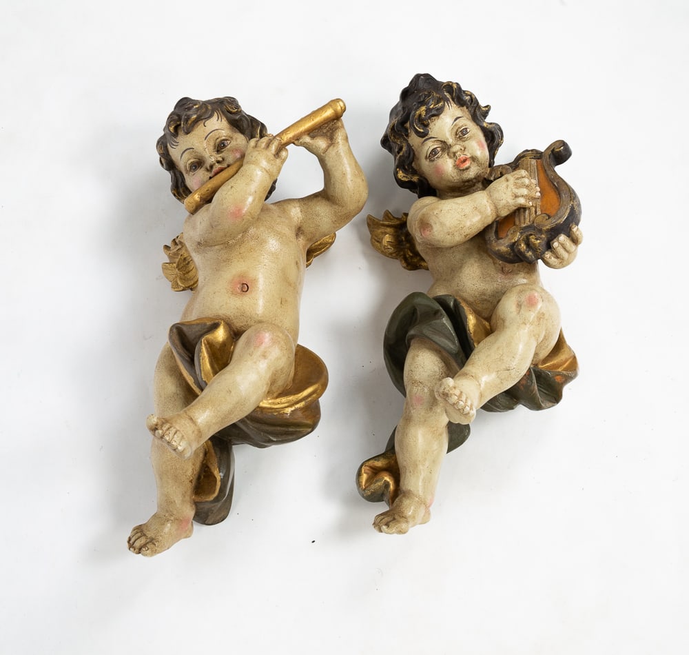 TWO CHERUB MUSICIAN WALL HANGINGS.: European, 20th Century. Composition. In the 17th Century Style. One playing a flute, 18"h. And one with harp, 19"h.