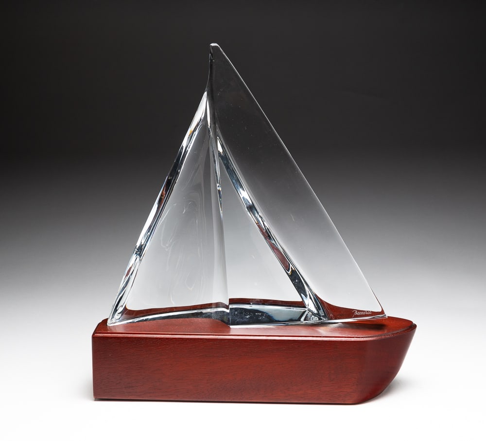 SIGNED BACCARAT GLASS SCULPTURE.: French, Contemporary. Titled "Ailzee" (Trade Wind). Sail shaped crystal, signed on front and bottom, on a fitted mahogany base. 14"h. 13.25"w. 4.5"d.
