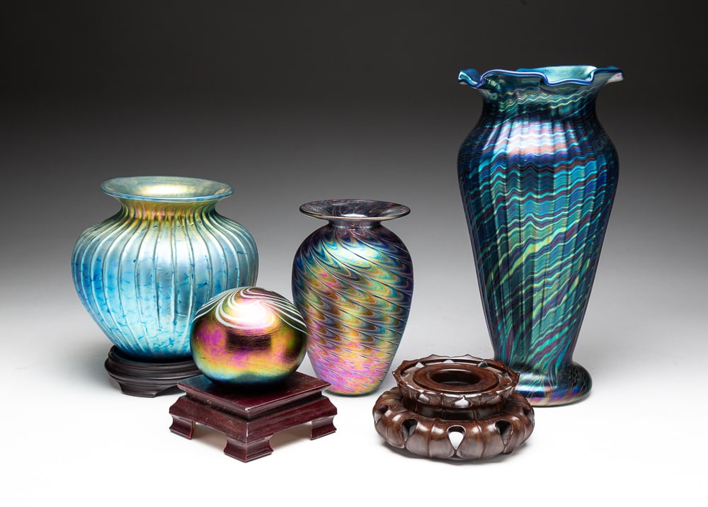 FOUR SIGNED IRIDESCENT STUDIO GLASS ARTICLES.: American, late-20th Century. Comprising two Lundberg Studio vases, the taller marked "L.S. 94" and the shorter marked "L.S. 8-5-95" and "J #1;" one Mt. St. Helens glass vase by The Glass Eye marked "T
