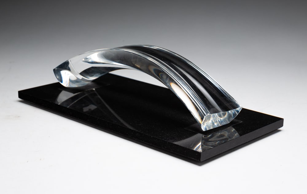 ROBERT CASSETTI FOR STEUBEN GLASS SCULPTURE.: American, late-20th Century. Low arched clear glass black marble base. 2.75"h. 10.25"w. 2.75"w. Base 12"w. 6"d.