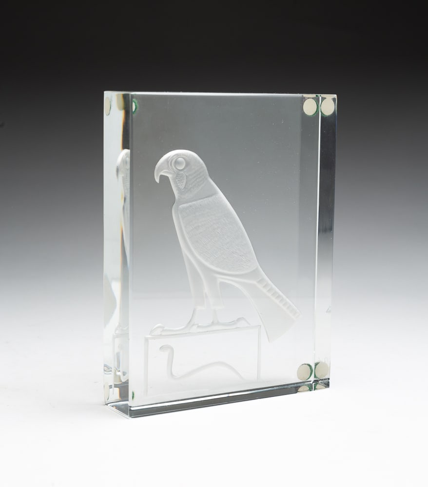 BACCARAT LIMITED EDITION "EGYPTIAN FALCON".: French, dated 1970. Crystal. Thick rectangular clear glass with deeply carved and etched falcon on base with asp decoration. Numbered 56/100, etched and acid etched mark. In original box. 6.45"h. 5.25
