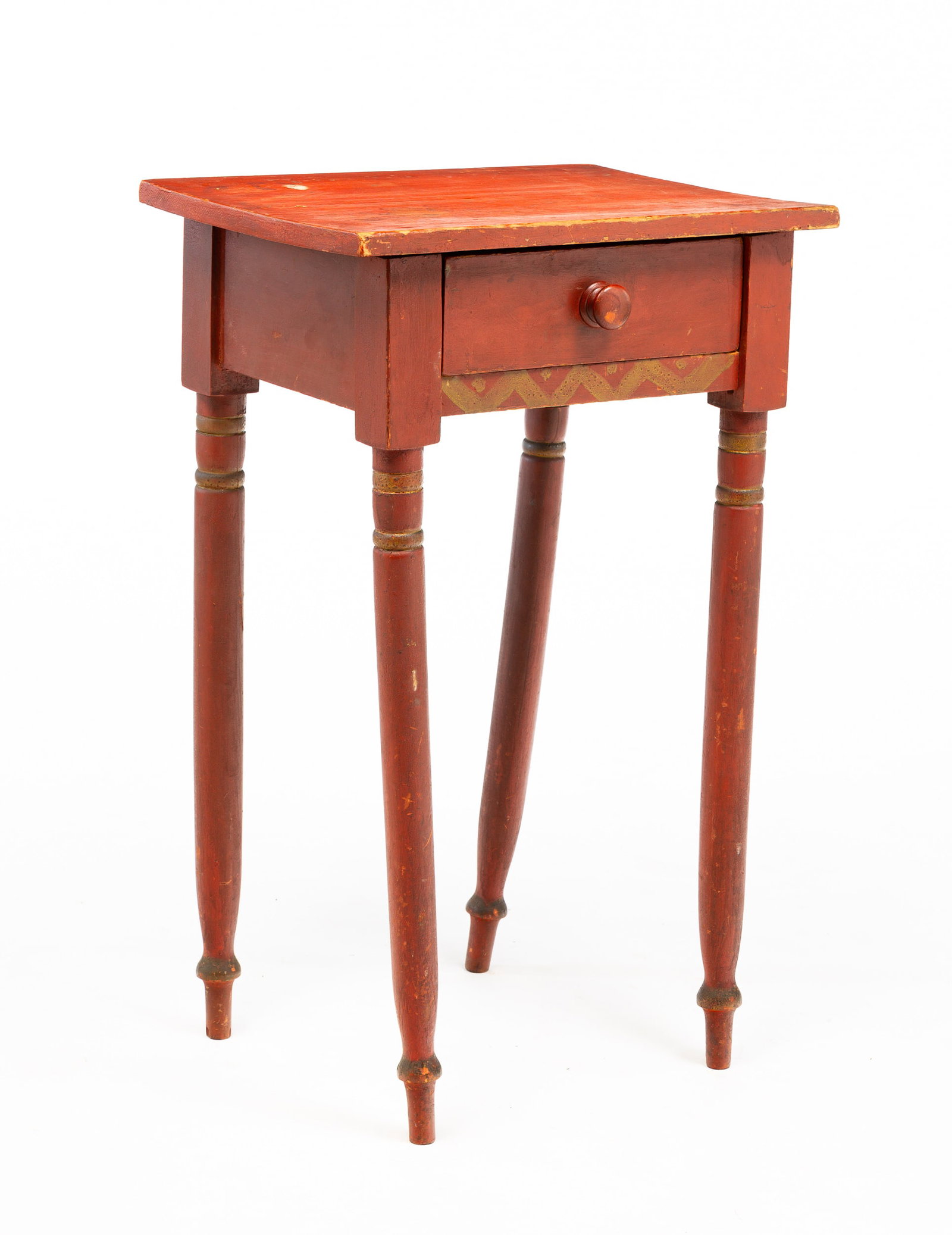 PAINT-DECORATED SHERATON STAND.: American, second quarter 19th Century. Overhung painted top above dovetailed drawer and simply turned legs. Original worn red paint and gold trim. 29.25"h., 18.25"w., and 13.75''d. From the collection