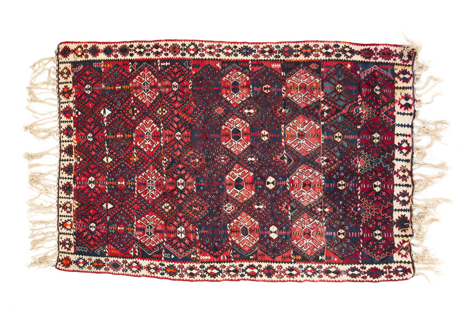 SENNEH KILIM RIG.: Persian, circa 1900. Blue and red field with geometric patterns and white border with geometric decoration. Knotted fringe to either end. Bleeding, fringe loss warping and traffic wear. 4'9.5"w. 6'10"
