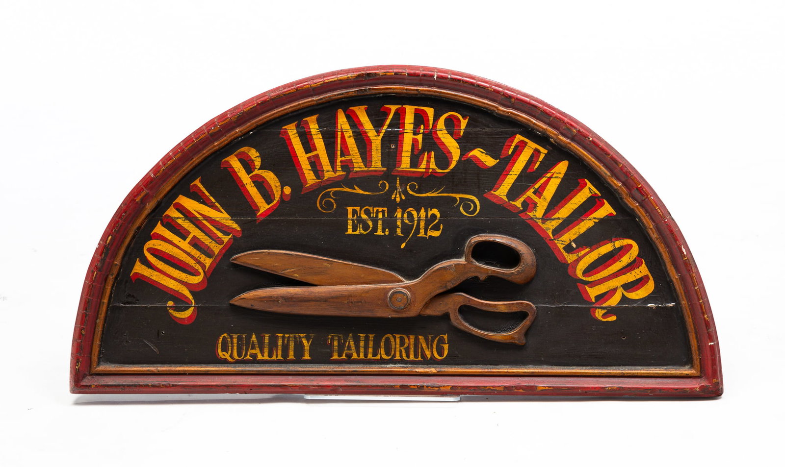 TAILOR TRADE SIGN.: American, 20th Century. Pine. Fan shaped with red and bronze frame, black background, three dimensional scissors and lettered in yellow and red shaded letters "John B. Hayes, Tailor Est. 1912 Quality 