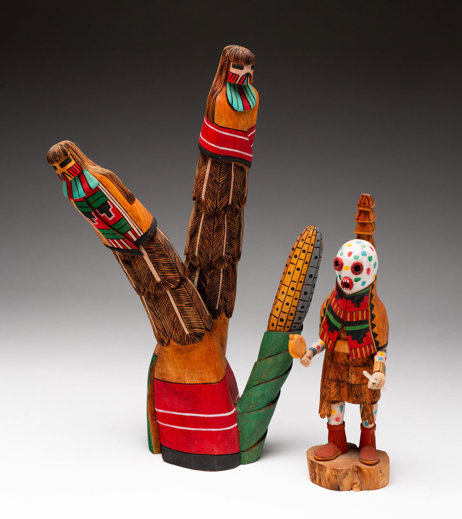 TWO HOPI KACHINA DOLLS.: Hopi, late-20th or early-21st Century. Polychrome painted cottonwood. The first a Corn Maiden, signed "MARVIN POLACCA CORN MAIDEN MANA TAKA WHITE HOPI TEWA." 14.5"h. The second an Earth God, signed "L
