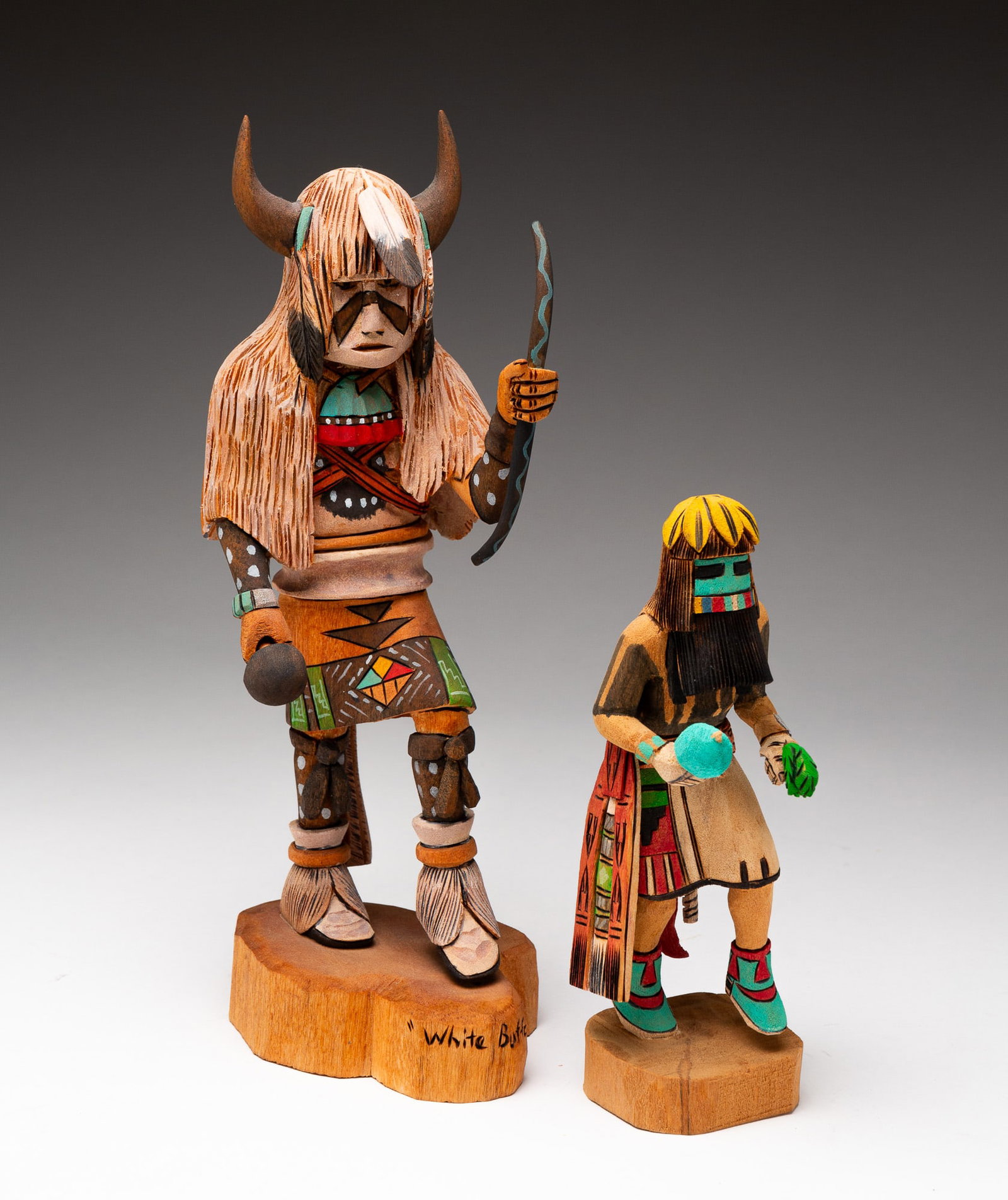 TWO HOPI KACHINA DOLLS.: Hopi, late-20th or early-21st Century. Polychrome painted cottonwood. The first a Long-Hair, signed "DAN BERT LONG-HAIR." 7.375"h. The second a White Buffalo, signed "D-Bert" with bear claw symbol. 11