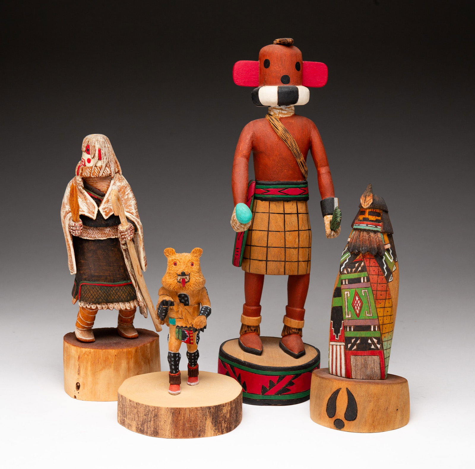 FOUR HOPI KACHINA DOLLS.: Hopi, late-20th or early-21st Century. Polychrome painted cottonwood. The first a Longhair, marked "KACHINA GIRL 93 HOPI" with illegible signature. 6.5"h. The second a Cold-Bringing Woman, signed "REN