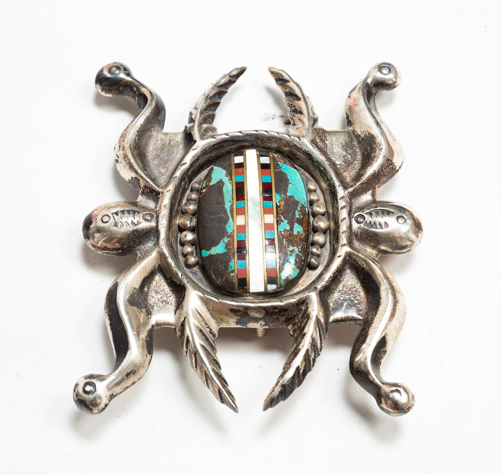NAVAJO SANDCAST SILVER AND INLAID BELT BUCKLE.: Mid-20th Century. Silver water bug motif with a central turquoise cabochon and inlaid with multiple stones. Stamped "3H" (Three Hogans) and etched "KN-132." 4"w. Total weight approx. 6.2ozt.