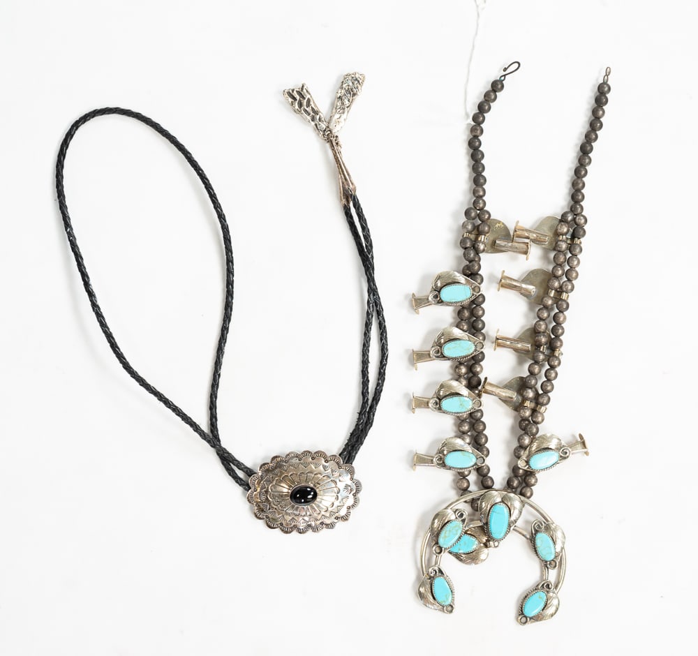 A NAVAJO STERLING SILVER TURQUOISE SQUASH BLOSSOM NECKLACE AND ONYX BOLO TIE.: Navajo, mid- to late-20th Century. Necklace with 10 sterling squash blossoms each set with a turquoise stone, the naja with six turquoise stones, strung with nickel silver beads. Unmarked. 13.25"l. To