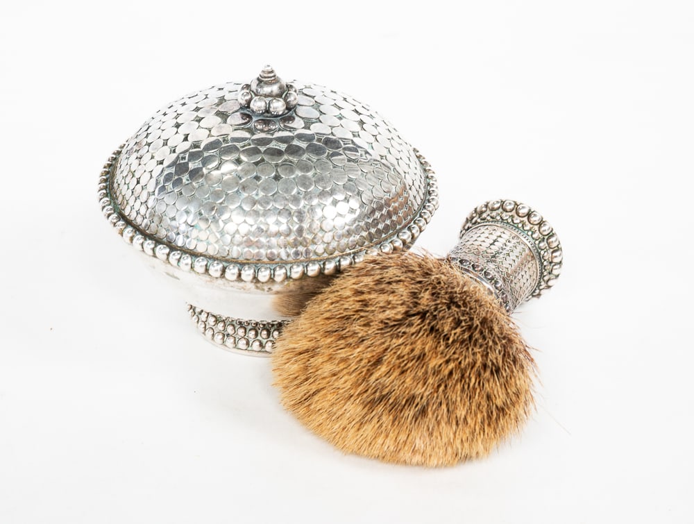 JOHN HARDY STERLING SILVER SHAVING BOWL AND BRUSH.: 20th Century. The shaving bowl with a matching lid, stamped "JH 925" on underside. The brush stamped "JH 925 INDONESIA". Height of bowl with lid 3.5"h. Total weight of both approx. 12.1ozt.