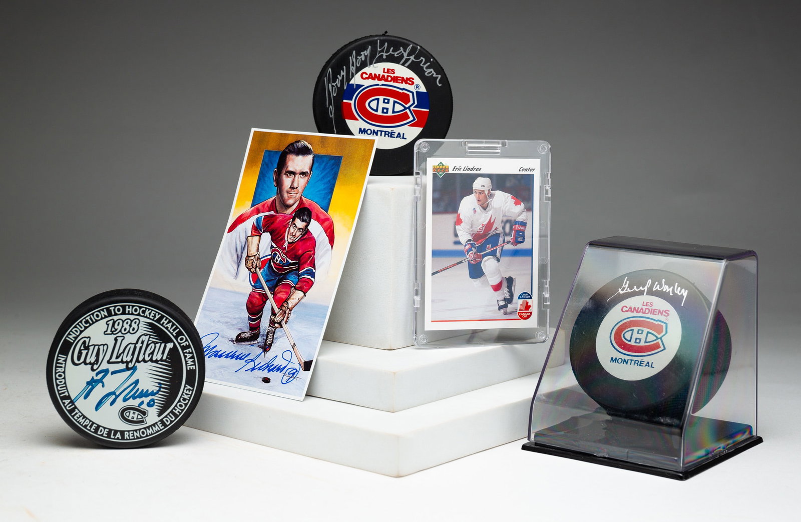 FIVE PIECES MONTREAL CANADIANS AUTOGRAPHED MEMORABILIA.: Canadian, 20th Century. Three pucks: Gump Worsley, Boom Boom Geoffrion and Guy Lafleur. Autographed Maurice Richard Legends of Hockey card, 5.5"h. 3.5"w. Eric Lindros (not autographed) trading card in