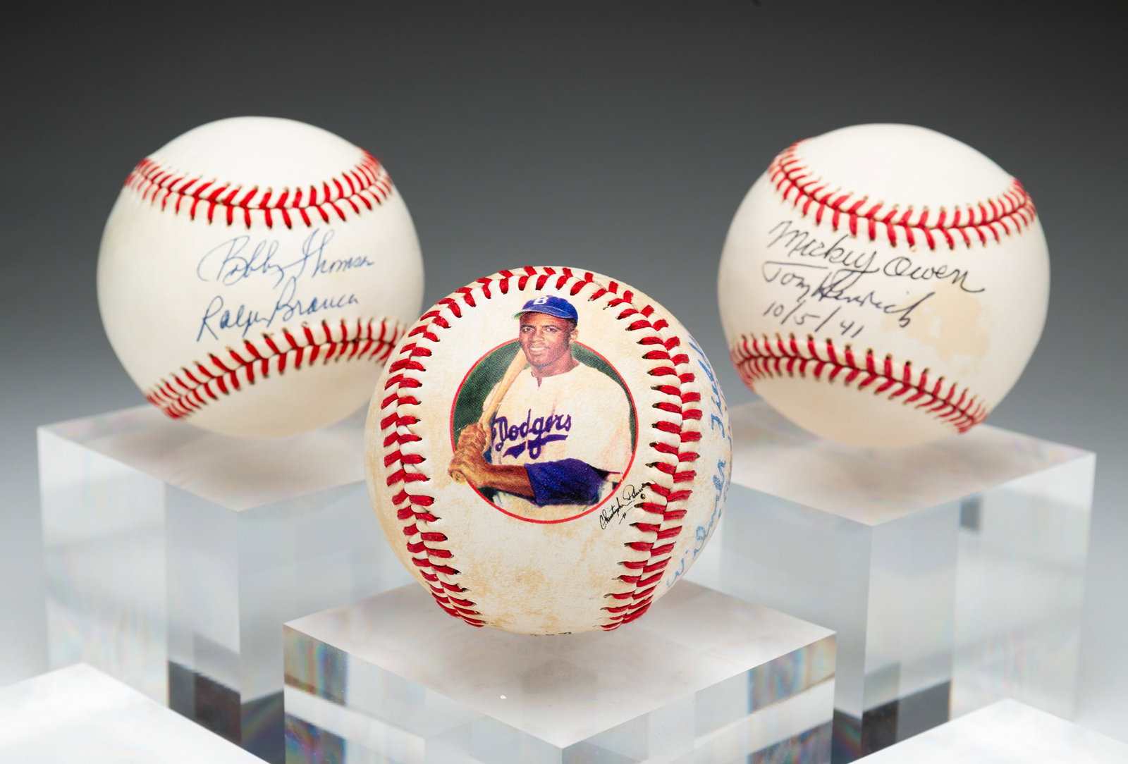 THREE AUTOGRAPHED BASEBALLS.: American, 20th Century. Includes two dual signed, Mickey Owen and Tommy Henrich and Bobby Thomson and Ralph Branca. And a Jackie Robinson ball signed by Larry Doby, Wilmer Fields, Bill "Ready" Cash an