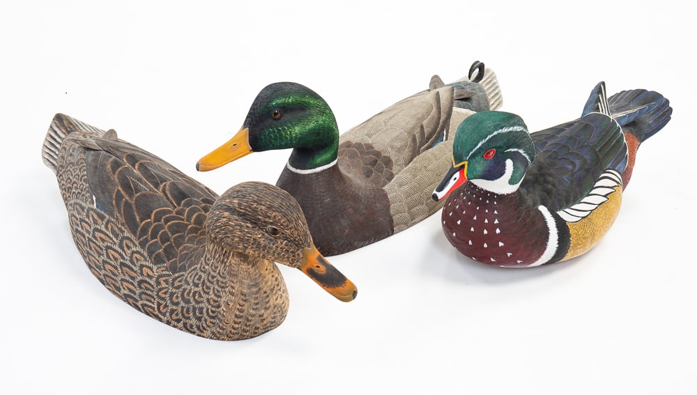 THREE SIGNED WOOD DUCK DECOYS.: American, late-20th Century. One signed by Ernest Lefort and two signed by Tim Hall. Largest 7"h. 18"l.