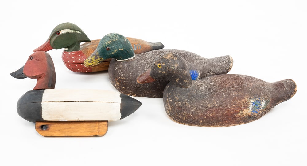 FOUR SIGNED WOOD DUCK DECOYS.: American, 20th Century. Two by Jack F. Rider initialed "JFR" and two signed by Guy Leslie. All with some attached hardware. 6.5"h. 16"l.