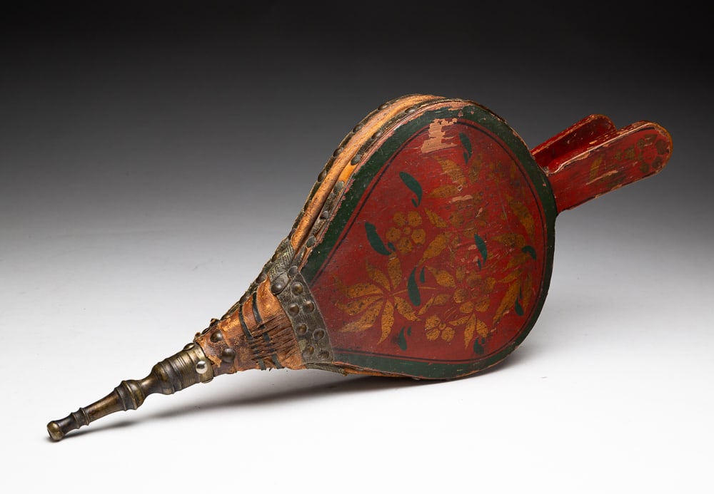 PAINT-DECORATED TURTLE-BACK BELLOWS.: American (possibly Pennsylvania), mid-19th Century. Turtle-back form with stenciled flowers and leaves in red, green and gold. 16.25"l.