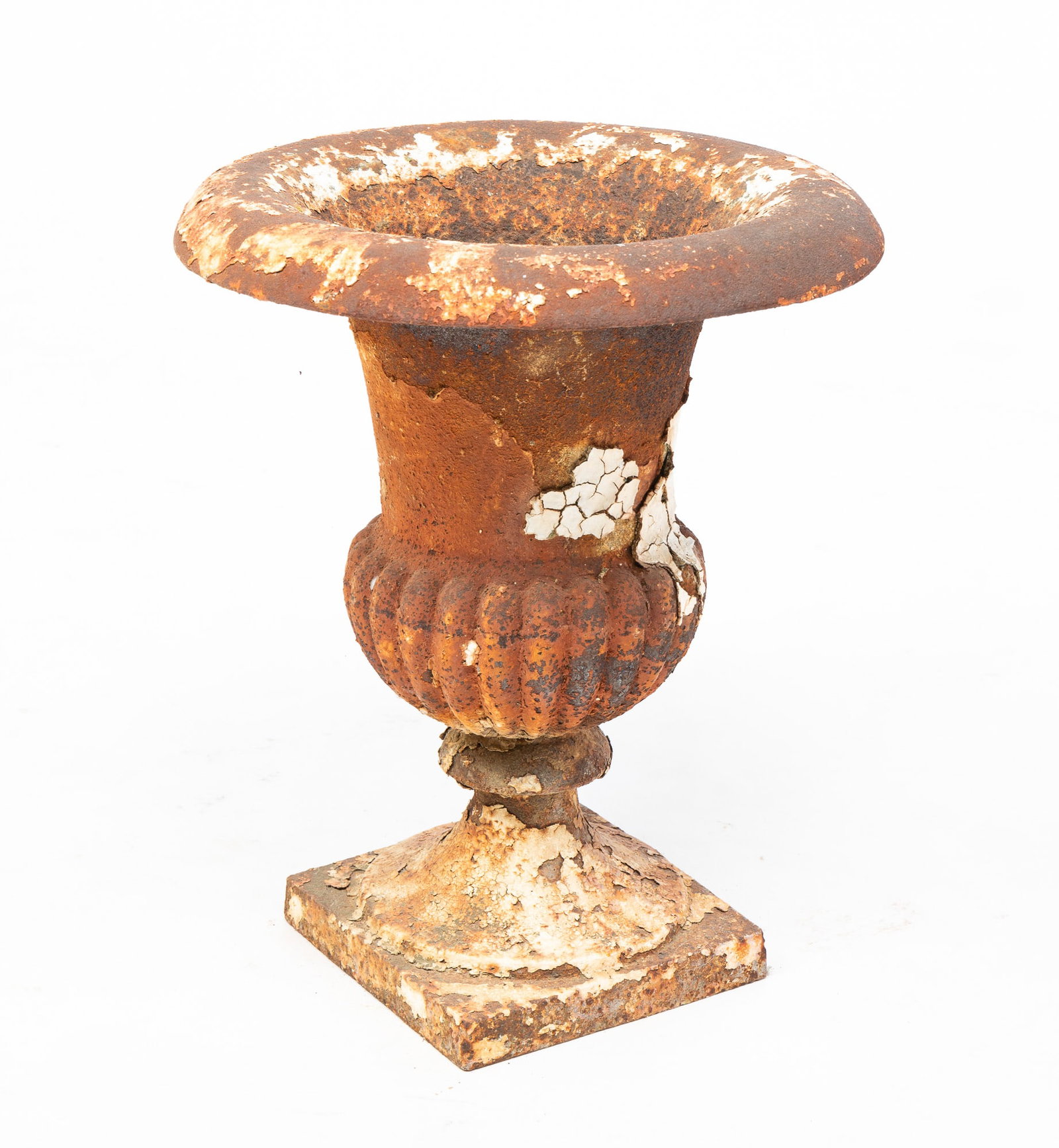 CAST IRON GARDEN URN.: American, second half 19th Century. Rounded flared rim, ribbed bowl, flange stem and square base. Remains of layered white paint. 18"h. 15" d.