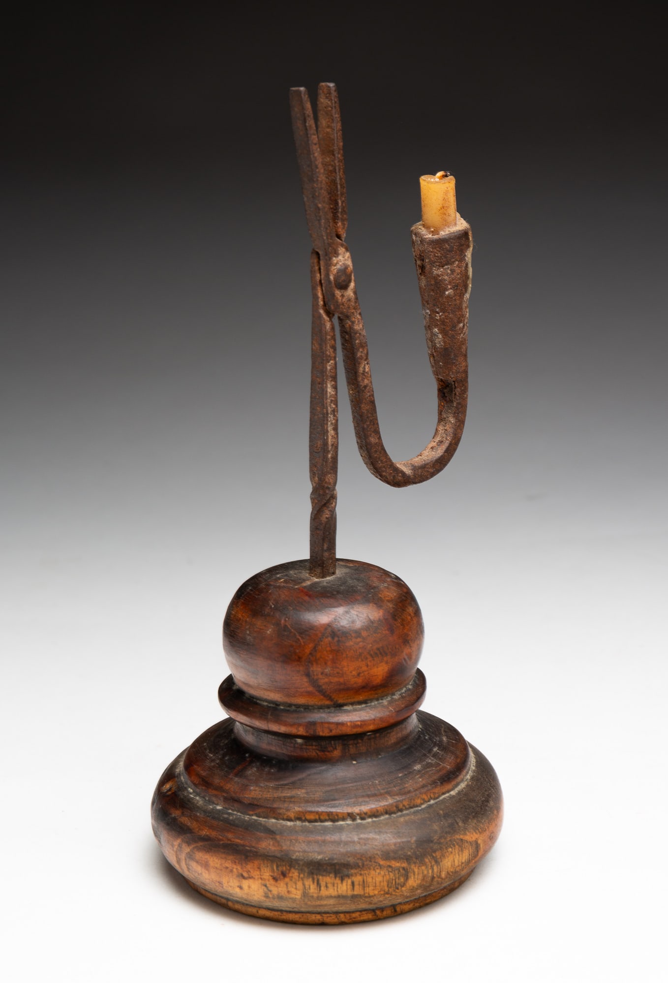 WROUGHT IRON RUSH LIGHT CANDLE HOLDER WITH TURNED WOOD BASE. (1 of 3)