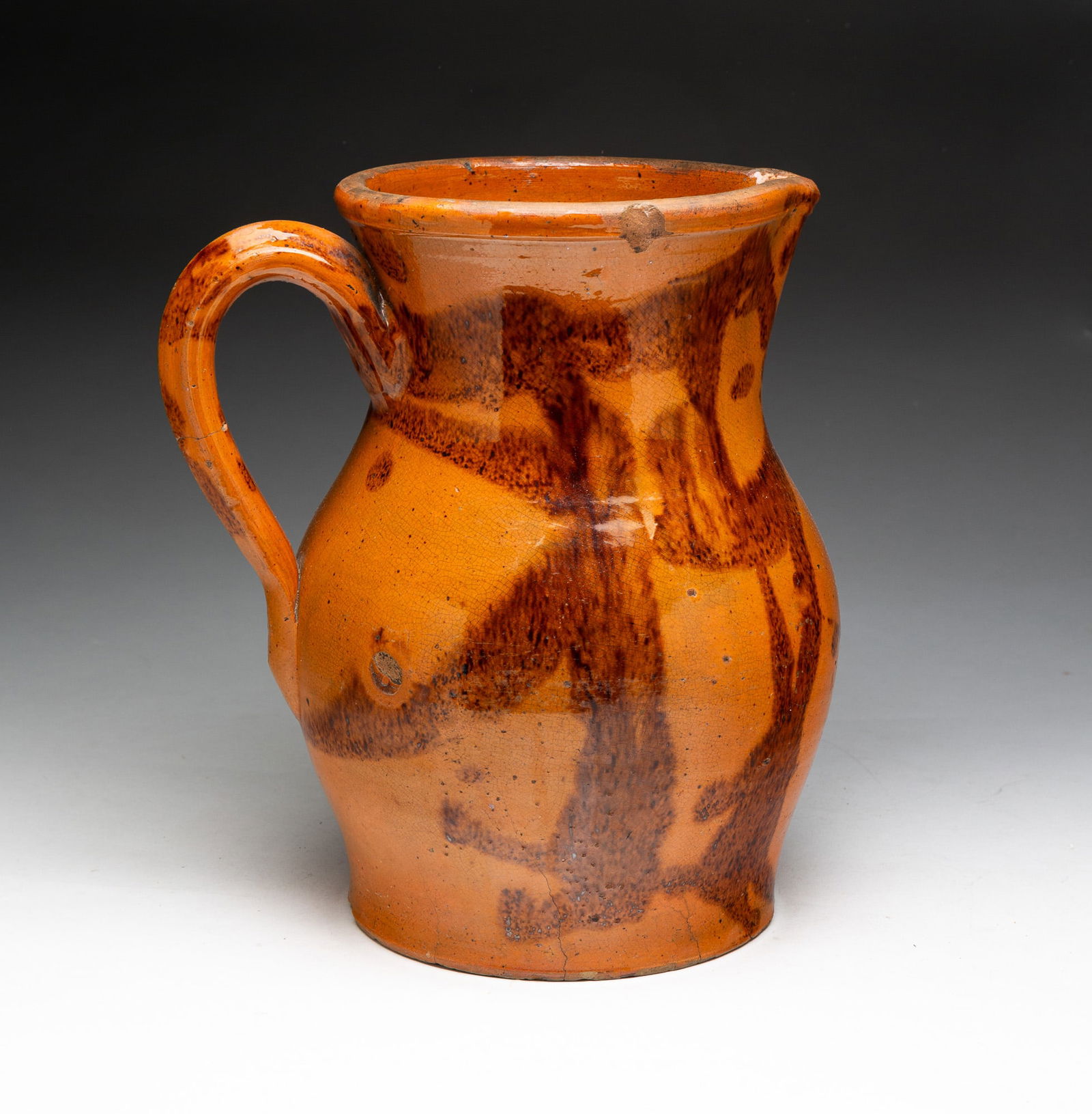 LARGE REDWARE PITCHER WITH MANGANESE DECORATION ATTRIBUTED TO KOCH POTTERY. (1 of 3)
