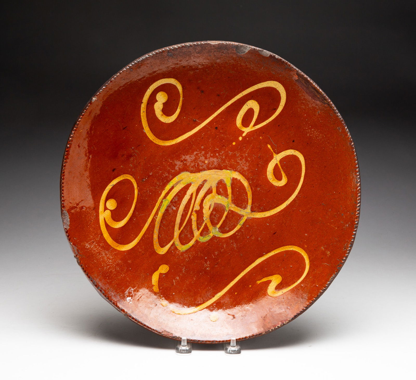 SLIP DECORATED REDWARE CHARGER. (1 of 3)