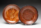 TWO SLIP DECORATED REDWARE SHALLOW BOWLS.