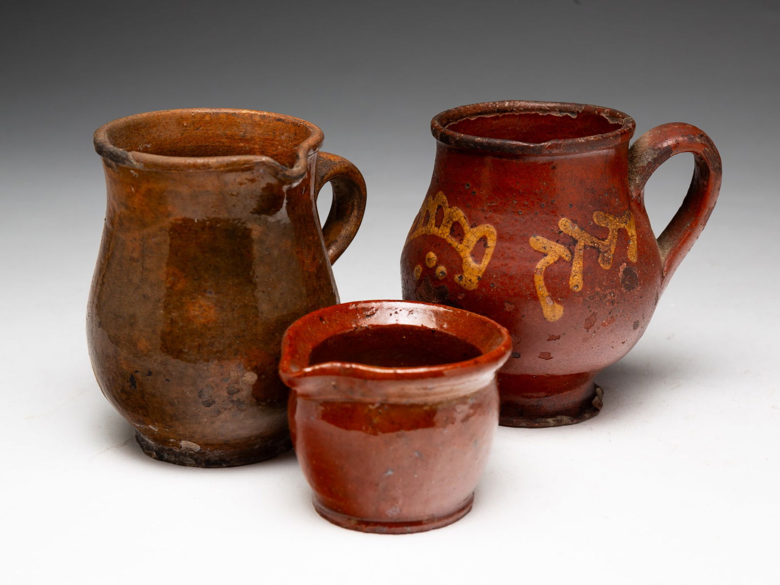 THREE PIECES OF HANDLED REDWARE. (1 of 3)