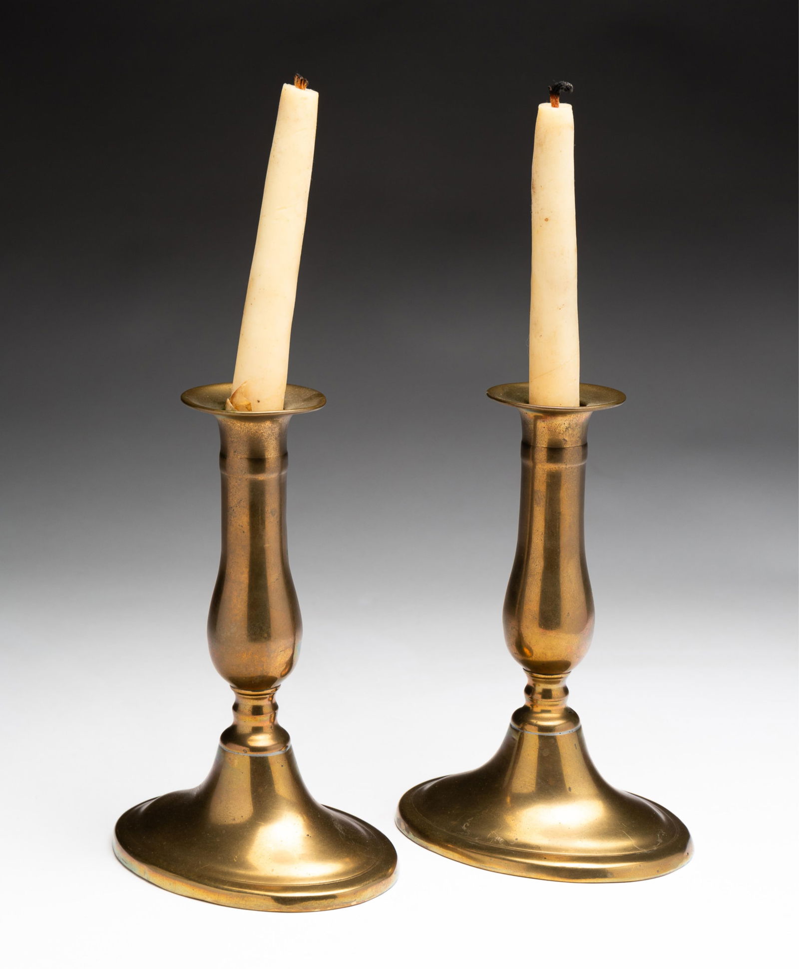PAIR OF BRASS CANDLESTICKS. (1 of 2)