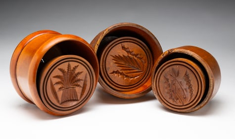 THREE CARVED WOOD BUTTER MOLDS.