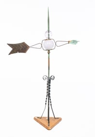 LIGHTNING ROD WITH POINTING HAND DIRECTIONAL AND GLASS BALLS.