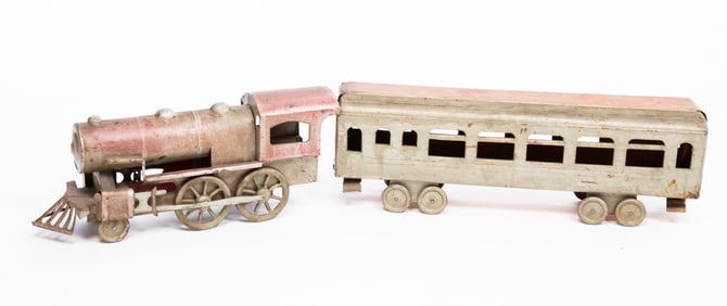 TOY STEAM LOCOMOTIVE AND PASSENGER CAR.