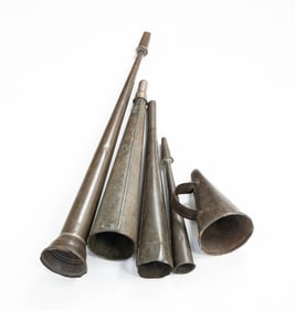 FIVE METAL PARADE HORNS.
