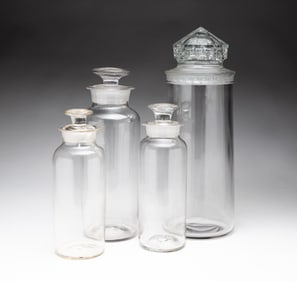 FOUR GLASS APOTHECARY JARS.