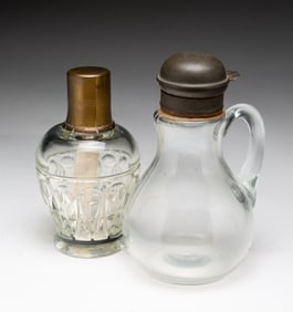 TIN LIDDED SYRUP JAR AND BRASS LIDDED KEROSENE LANTERN.