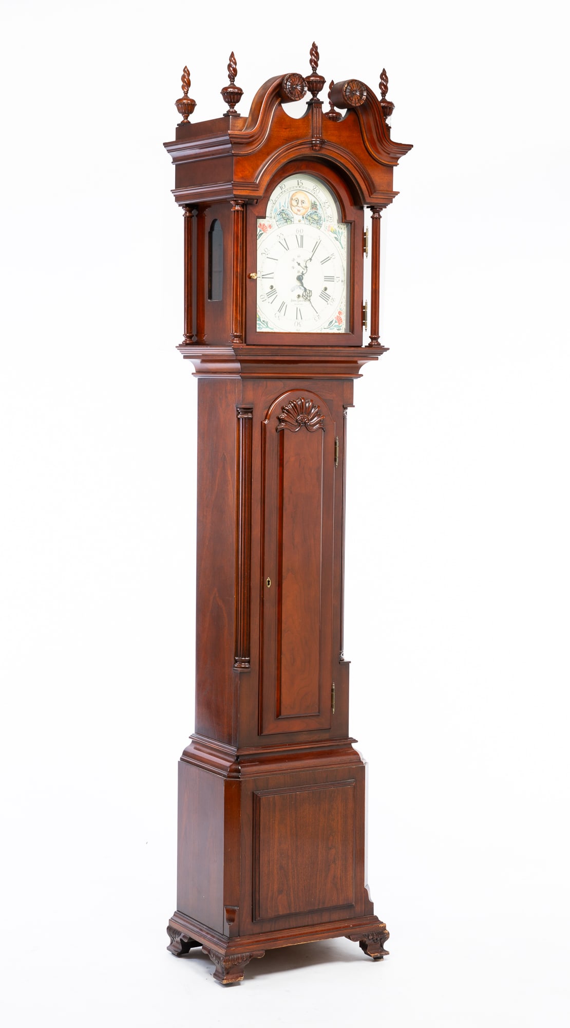 SLIGH CHIPPENDALE STYLE TALL CASE CLOCK.: American (Holland, Michigan), 20th Century. In the style of John Goddard. Hardwood. Bonnet with turned flame finals, broken arch pediment, arched door and half turned pilasters. Case with waist moldin