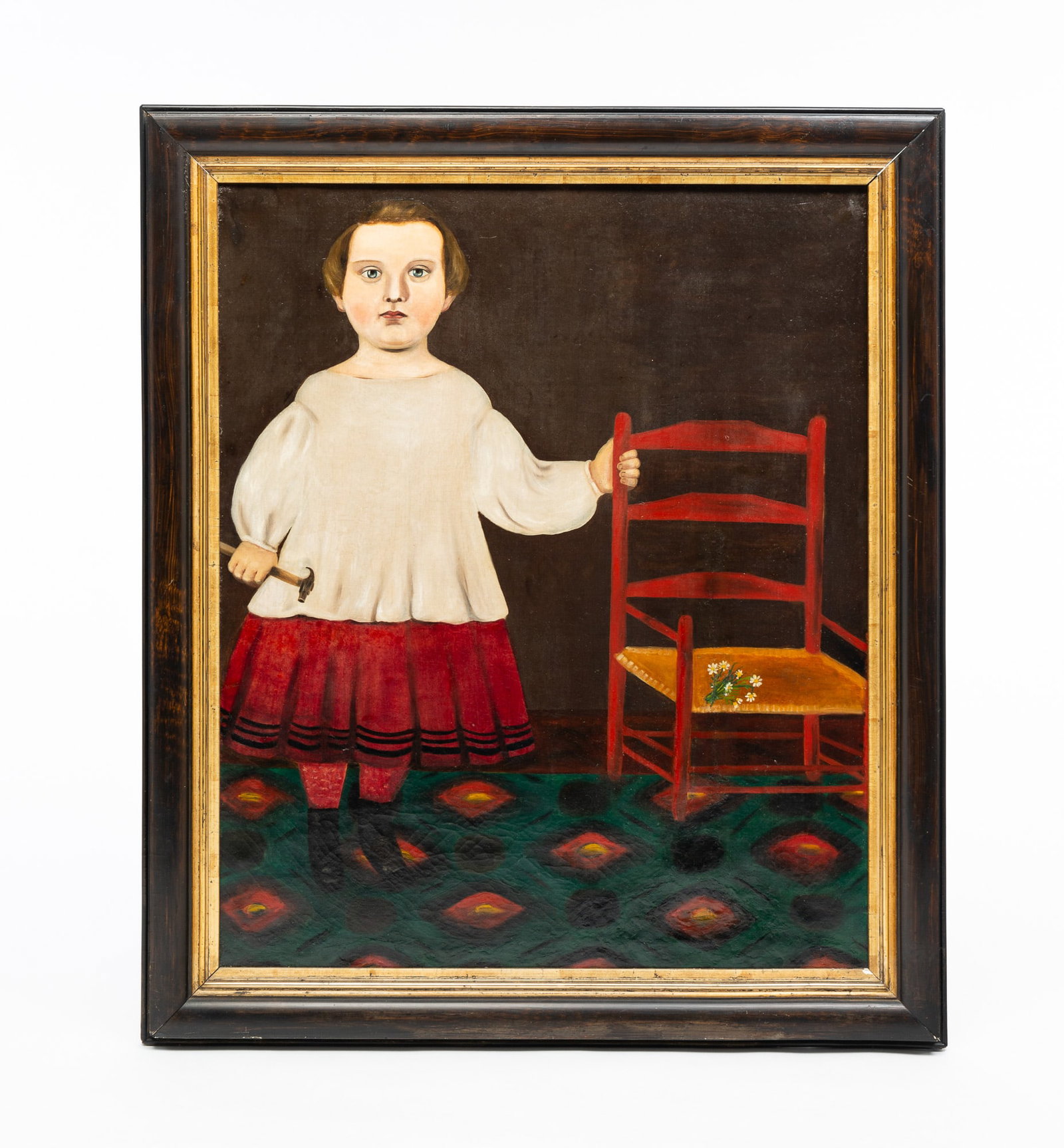 UNSIGNED FOLK ART PORTRAIT OF A CHILD.: American, 19th Century. Oil on canvas. Young child wearing a white sweater and red skirt standing next to a painted chair holding hammer. 30"h. 25.25"w. In painted wood frame with gilt liner, 35.25"h.