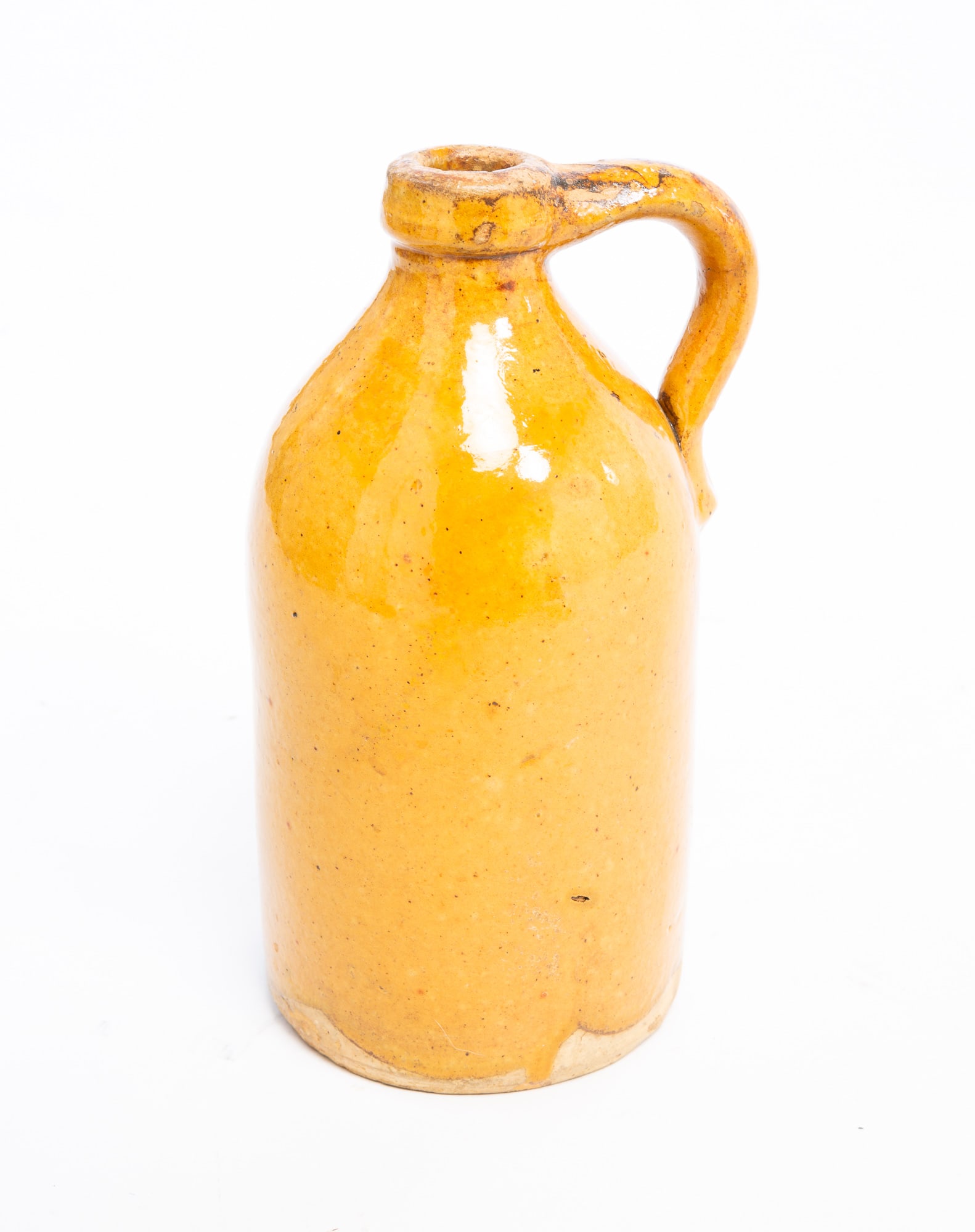 YELLOW GLAZED EARTHENWARE JUG. (1 of 3)