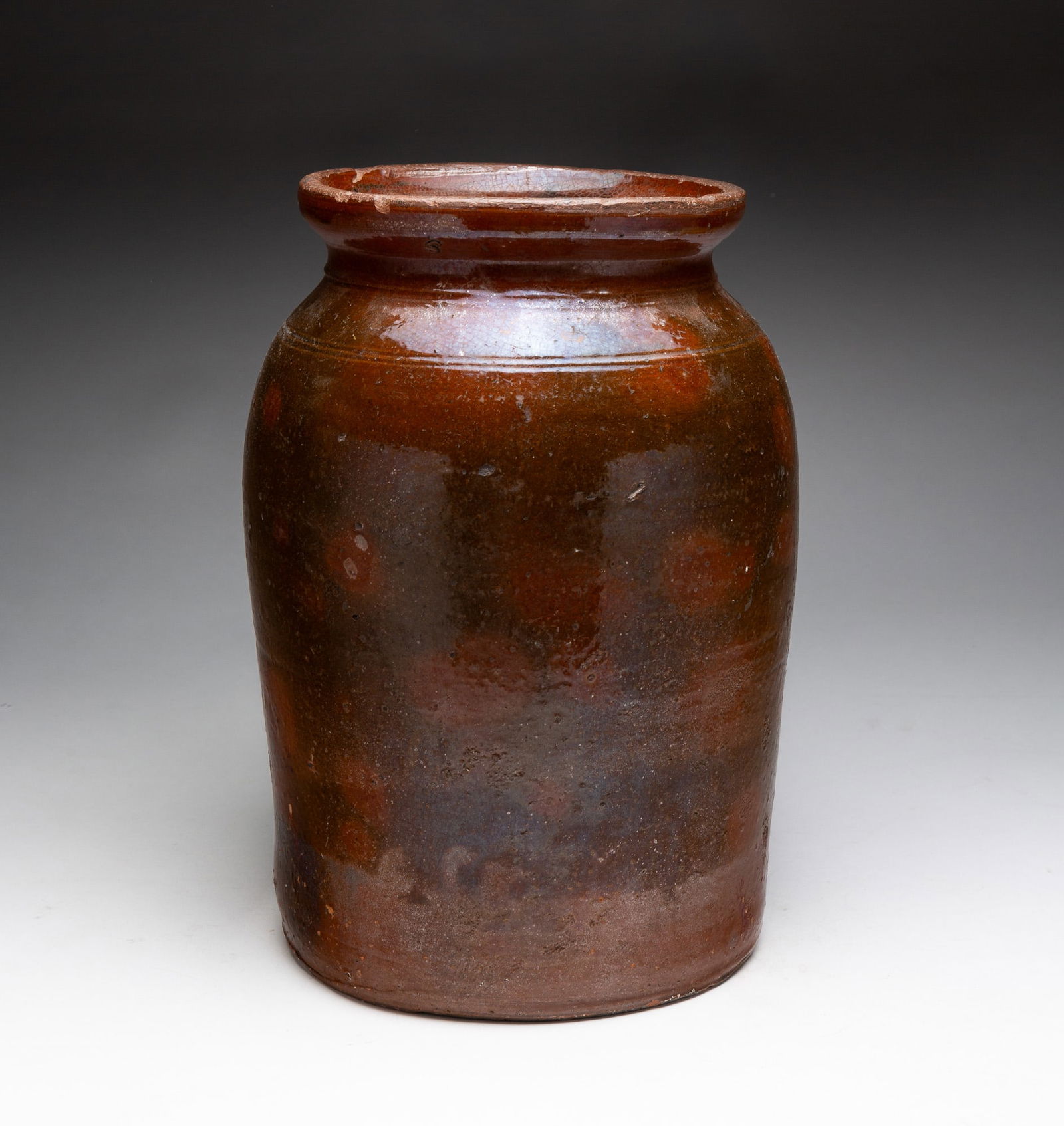 GALENA REDWARE JAR.: American, 19th Century. Well formed neck with tooling at shoulder and mottled orange and greenish-brown glaze. 12.5"h.From the collection of the late Neil Zuehlke, Heartland, Wisconsin.
