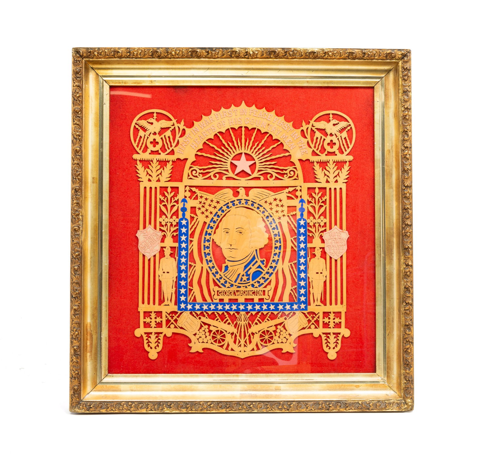 FRAMED SCROLLWORK PLAQUE OF GEORGE WASHINGTON.: American, 20th Century. Red flannel background. Blue stars, cannons, drums, and WWI soldiers,reading "First in war, first in peace, first in hearts of his countrymen", in gilt wood frame. 32.5"h. 31"w