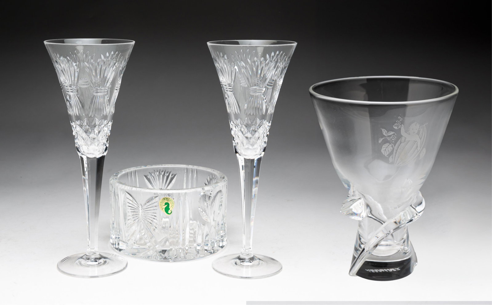 STEUBEN AND WATERFORD CRYSTAL ITEMS.: American, late 20th Century. Steuben vase in a spiral form on circular base and engraved with the Hershey Cocoa Bean Baby trademark and the dates of the centennial, 1894-1994. Signed and in original b