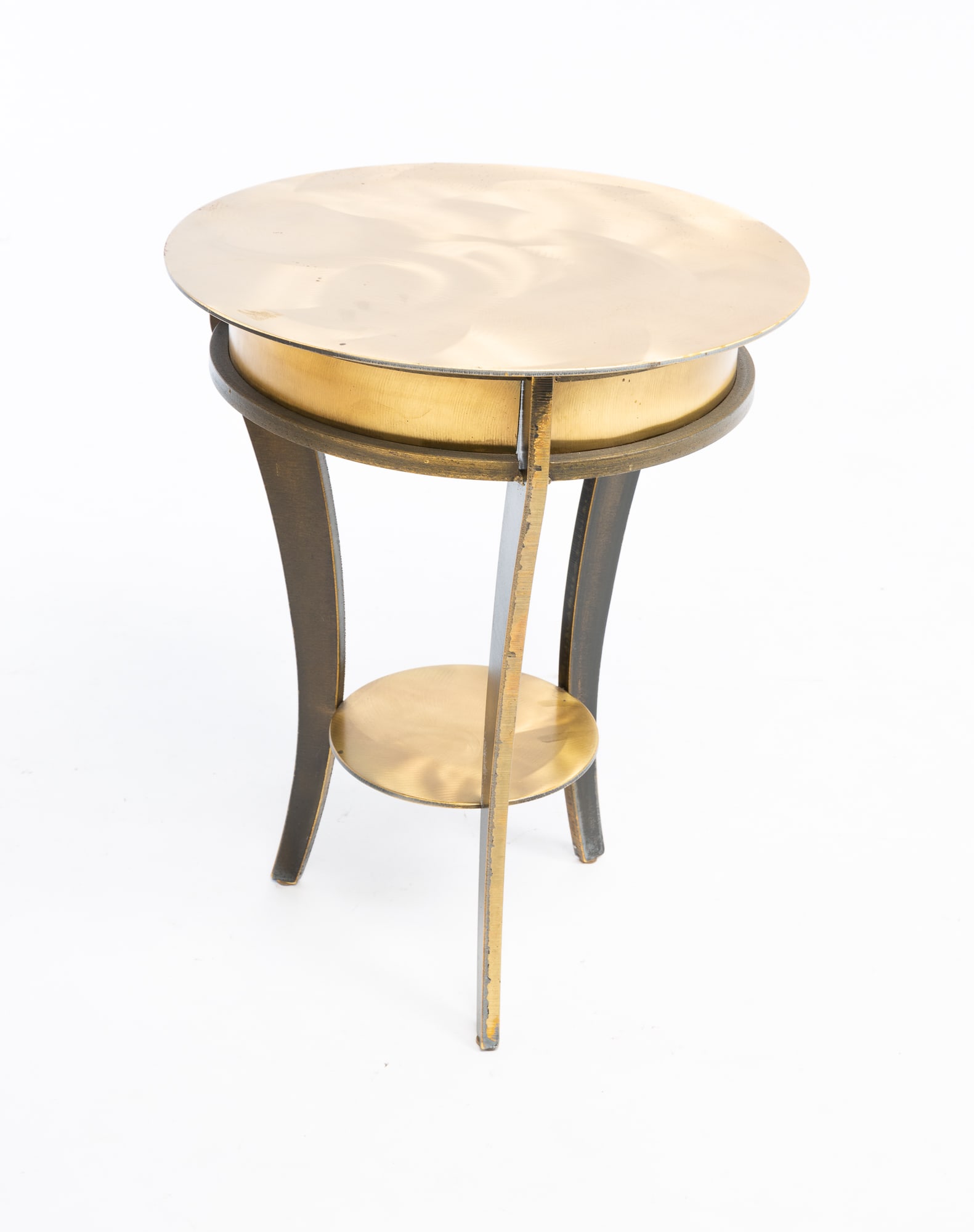 ROUND SIDE TABLE IN THE STYLE OF JOHN VESEY (1924-1992).: American, 20th or 21st Century. Solid brass three leg round industrial side table with bottom shelf, with brushed finish. 20?h. 16?dia top.