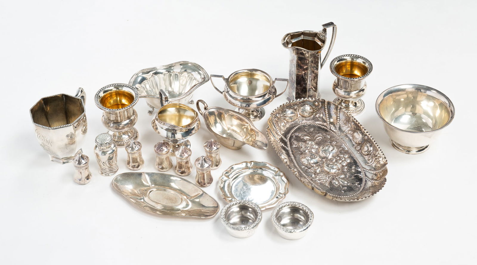 ASSORTED STERLING SILVER TABLE ACCESSORIES.: Amerinca, English and Mexican, 20th Century. Includes S. Kirk and Son Paul Revere bowl, toothpicks, salt and pepper shakers, a diminutive gravy boat and underplate, footed dish, creamers and an 800 si