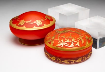 TWO ART GLASS POWDER JARS BY DEVILBISS.